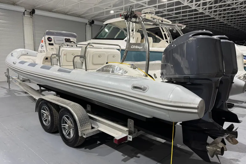 Slide: The Image of 2010 Cobra Ribs Nautique 8.6m boat on trailer in indoor storage facility. - 7