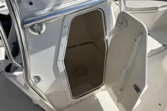 Slide: The Image of 2019 Cobia 237 Center Console boat with open storage compartment door. - 10