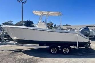 Slide: The Image of 2019 Cobia 237 Center Console boat on trailer, side view, outdoors. - 3