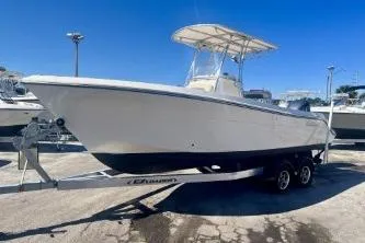 Slide: The Image of 2019 Cobia 237 Center Console boat on trailer under clear blue sky. - 4