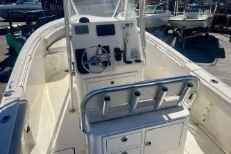 Slide: The Image of 2019 Cobia 237 Center Console boat interior with steering wheel and storage compartments. - 7