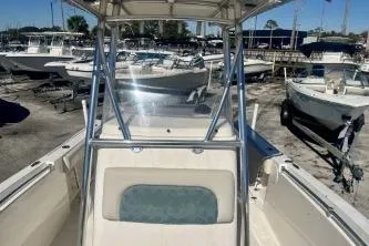 Slide: The Image of 2019 Cobia 237 Center Console boat in a marina with other vessels. - 9