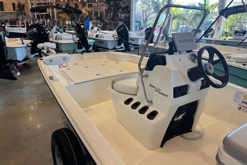 Slide: The Image of 2025 Mako Pro Skiff 15 CC boat with Garmin navigation system in showroom. - 3