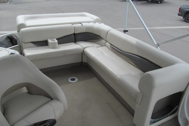 Slide: The Image of 2008 Sun Tracker Party Barge 25 I/O Regency Edition interior with plush seating and cup holder. - 12