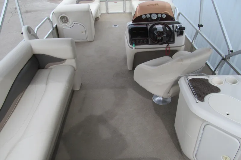 Slide: The Image of 2008 Sun Tracker Party Barge 25 I/O Regency Edition interior with seating and helm. - 5
