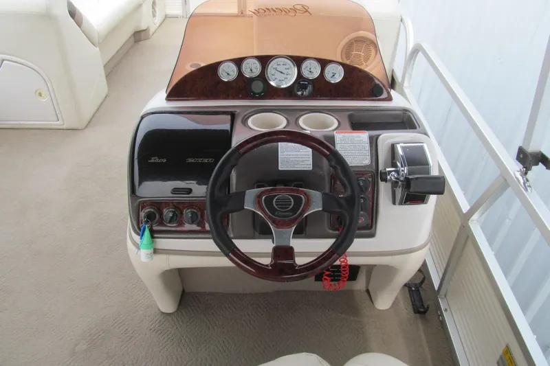 Slide: The Image of 2008 Sun Tracker Party Barge 25 I/O Regency Edition dashboard with steering wheel and controls. - 6