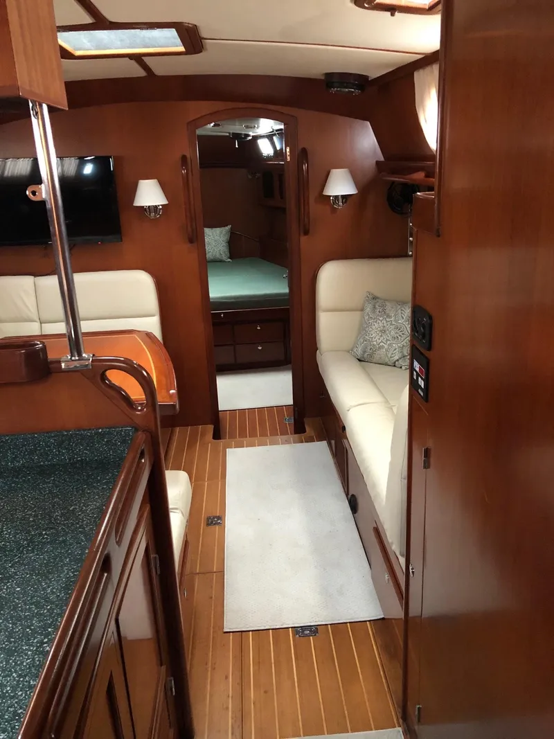 Slide: The Image of Interior of 2000 Outbound 44 yacht with wood finish and cozy seating area. - 1