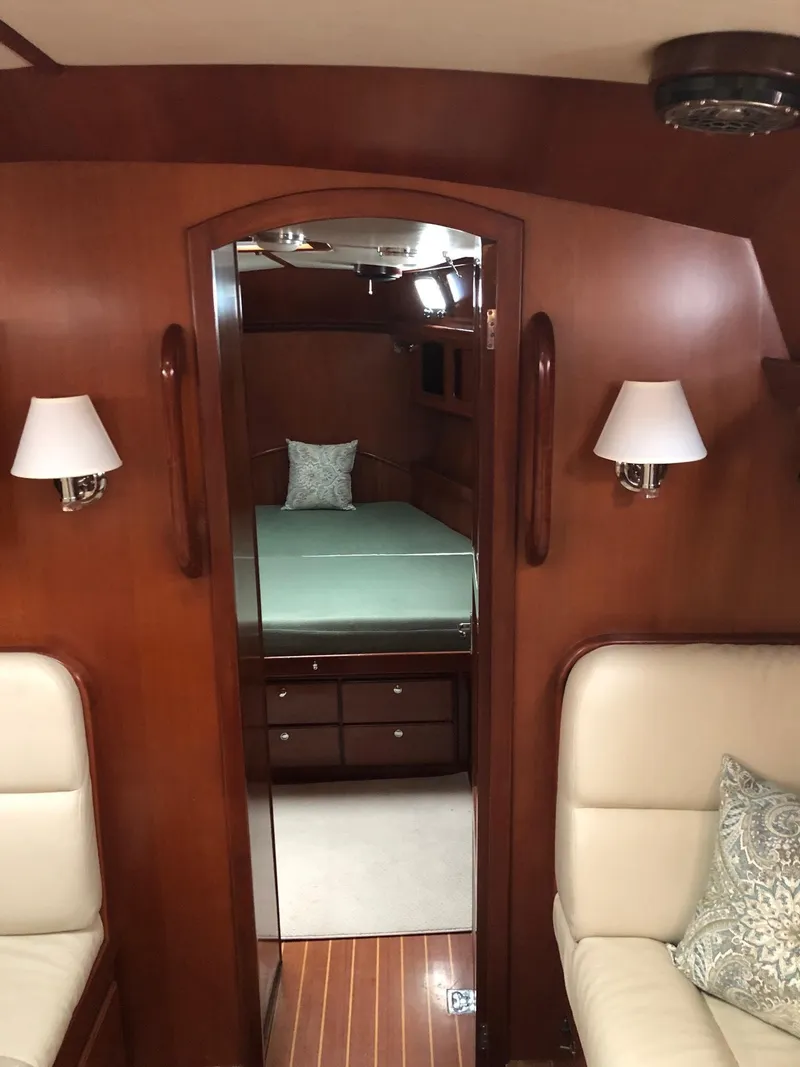 Slide: The Image of Interior of 2000 Outbound 44 yacht with wood paneling and cozy seating. - 10