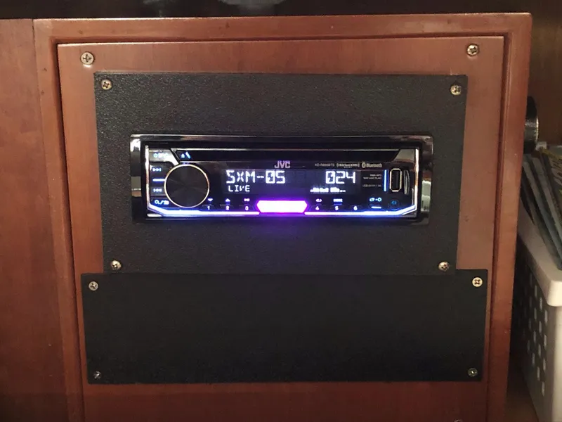 Slide: The Image of JVC car stereo installed in a wooden dashboard of a 2000 Outbound 44. - 11