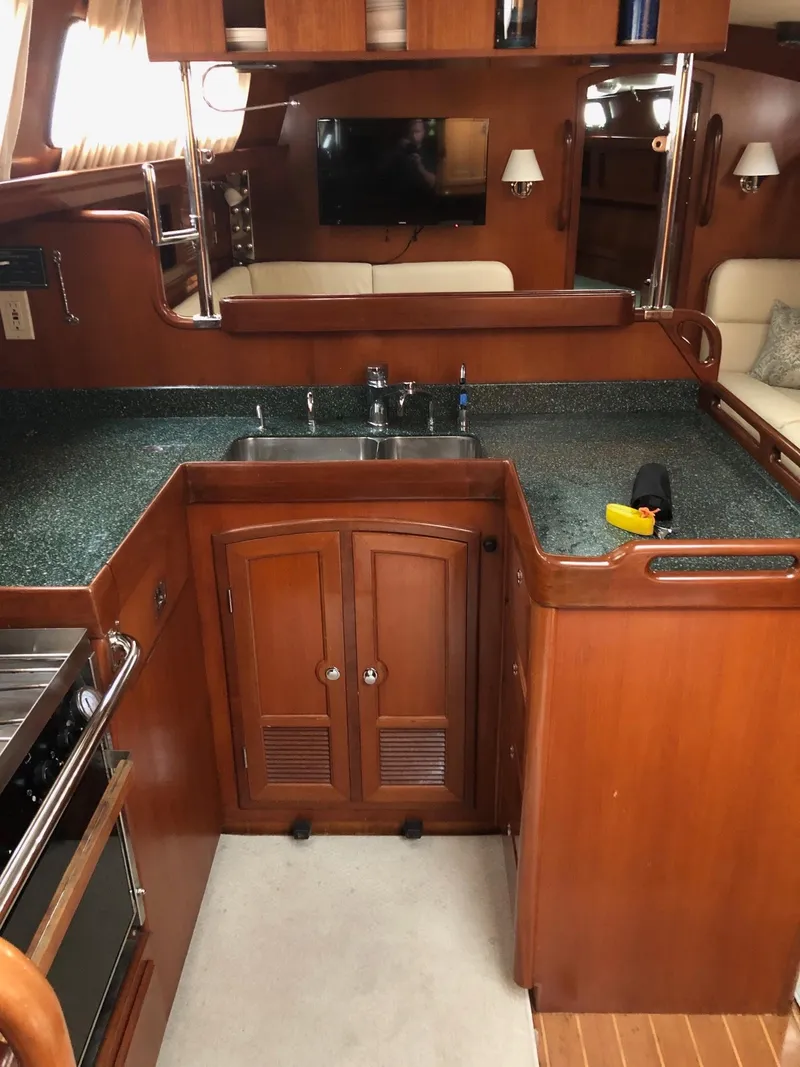 Slide: The Image of Interior of 2000 Outbound 44 yacht with wooden cabinetry and modern kitchen amenities. - 3