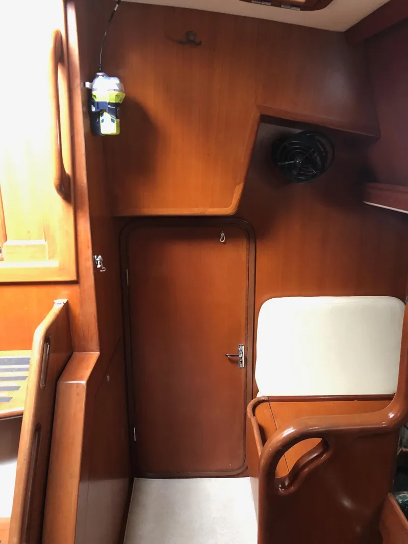 Slide: The Image of Interior of 2000 Outbound 44 sailboat with wooden paneling and seating area. - 49