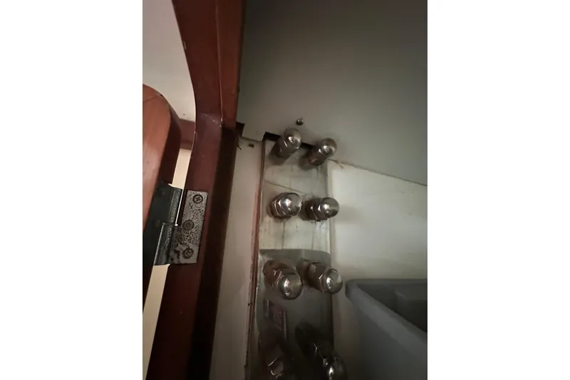 Slide: The Image of Interior view of Outbound 44 yacht, showing door hinge and metal fittings, year 2000 model. - 56