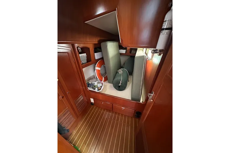 Slide: The Image of Interior of 2000 Outbound 44 sailboat with wooden cabinetry and storage area. - 61