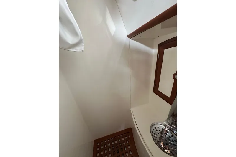 Slide: The Image of Shower area in 2000 Outbound 44 yacht with wooden accents and chrome fixtures. - 62