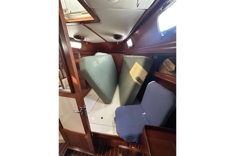 Slide: The Image of Cabin interior of 2000 Outbound 44 sailboat with cushions and wooden finish. - 66