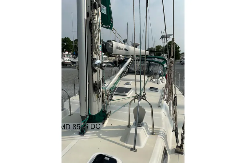 Slide: The Image of Sailboat deck view of 2000 Outbound 44, featuring rigging and mast details. - 67