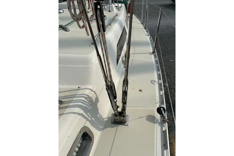 Slide: The Image of Deck view of a 2000 Outbound 44 sailboat, featuring rigging and safety lines. - 68