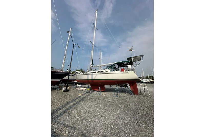 Slide: The Image of Outbound 44 sailboat from 2000 on dry dock, with clear sky background. - 72