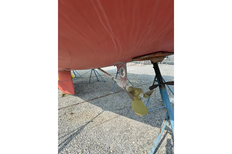 Slide: The Image of Bottom view of a 2000 Outbound 44 sailboat on stands, showing propeller and rudder. - 73