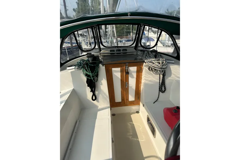 Slide: The Image of Cockpit of 2000 Outbound 44 sailboat with ropes and wooden cabinet. - 76