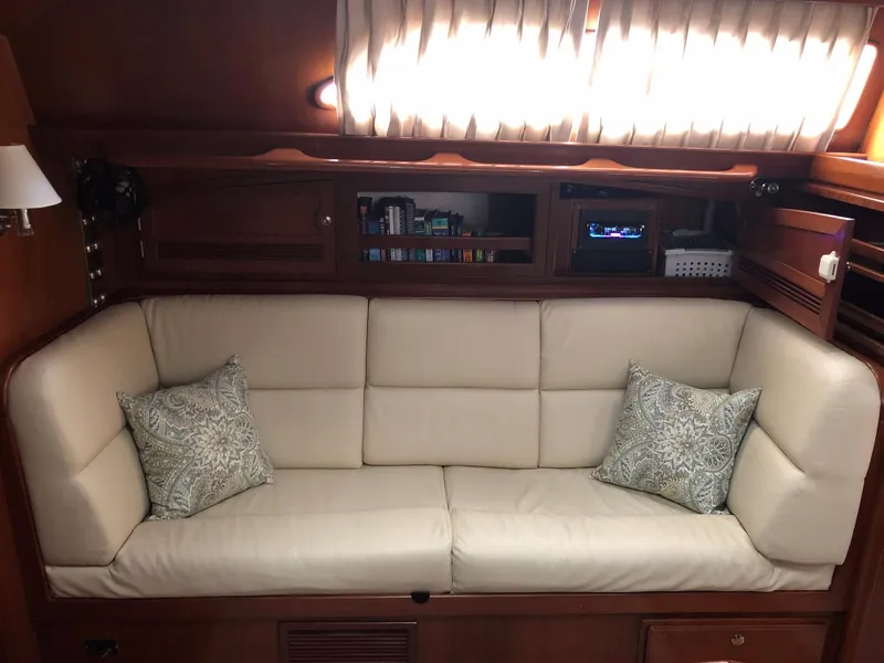 Slide: The Image of Luxurious interior of 2000 Outbound 44 yacht with cream sofa and decorative pillows. - 9