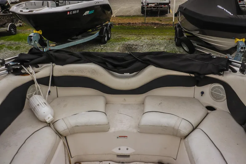 Slide: The Image of 2006 Yamaha Boats SX210 interior with white seating and black cover. - 12