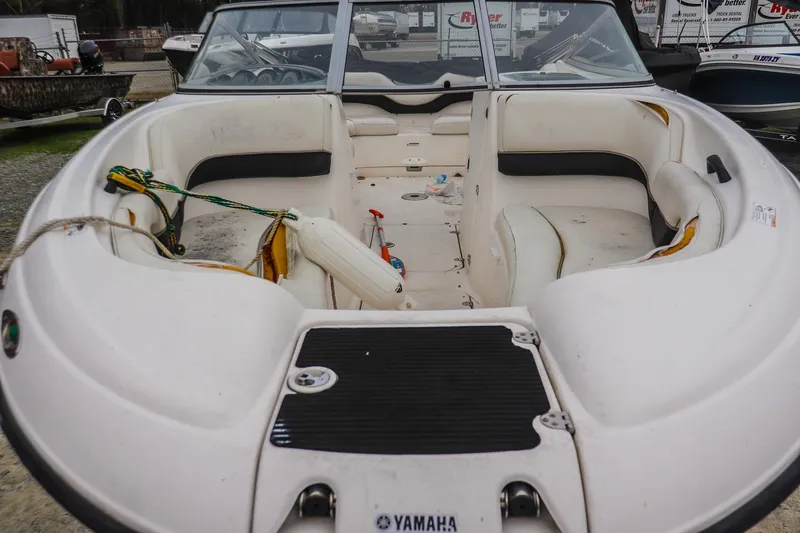 Slide: The Image of 2006 Yamaha Boats SX210 interior with white seating and open deck layout. - 8