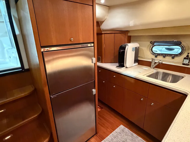 Slide: The Image of Interior of 2008 Tiara Yachts 4300 Sovran with kitchen and stainless steel refrigerator. - 18