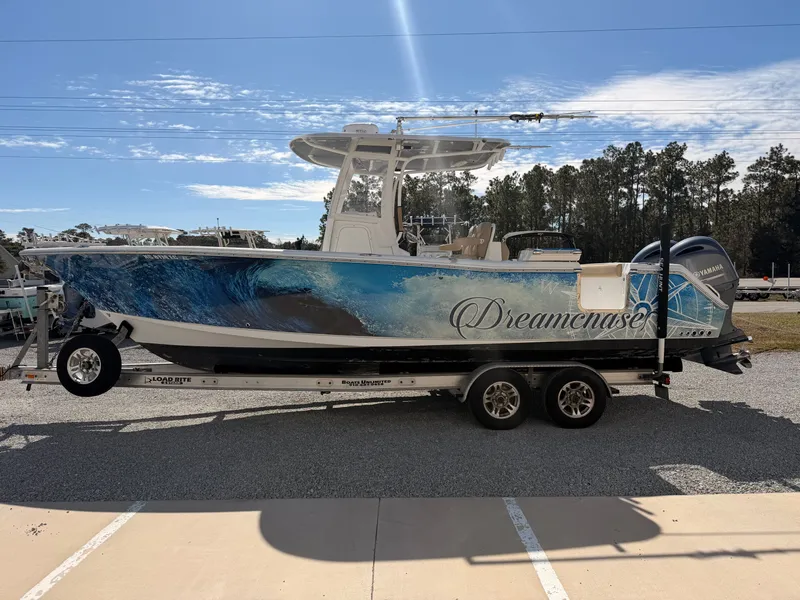 Slide: The Image of 2016 Sea Hunt Gamefish 27 boat on trailer, named "Dreamchaser." - 4