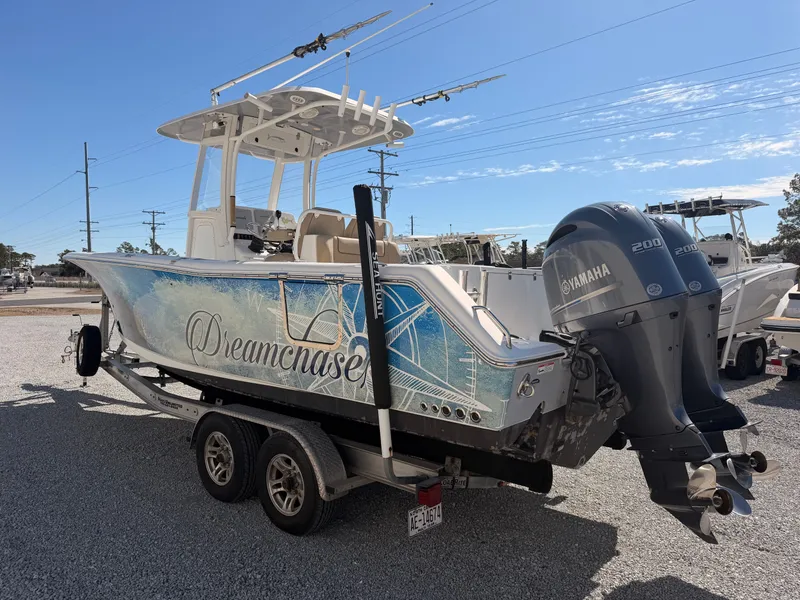 Slide: The Image of 2016 Sea Hunt Gamefish 27 boat with Yamaha engines on trailer. - 6