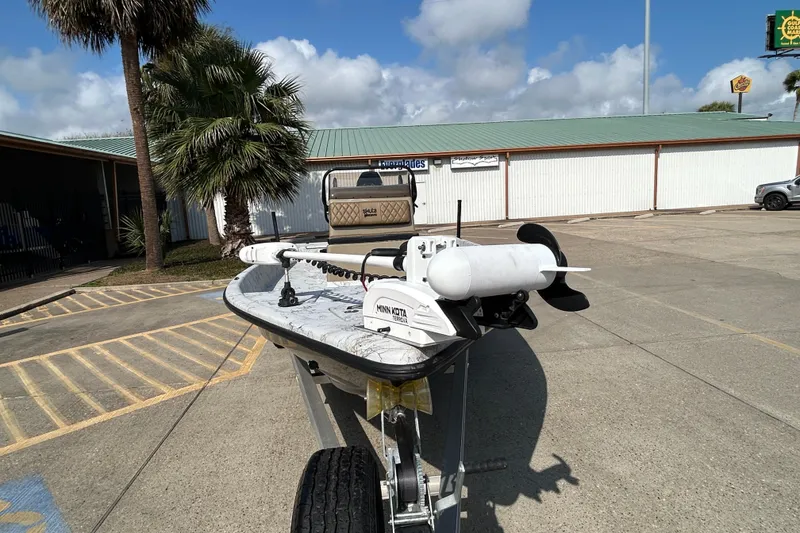 Slide: The Image of 2026 Skuta 24 Vista boat on trailer in sunny parking lot. - 5