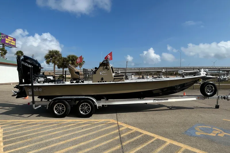 Slide: The Image of 2026 Skuta 24 Vista boat on trailer, parked outdoors under a clear sky. - 7