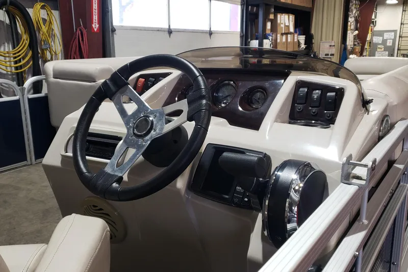 Slide: The Image of 2014 Bennington 22SSX boat dashboard with steering wheel and control panel. - 7