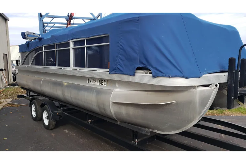 Slide: The Image of 2014 Bennington 22SSX pontoon boat with blue cover on trailer. - 9