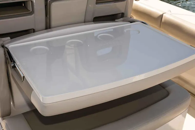 Slide: The Image of Manufacturer Provided Image: Boston Whaler 330 Outrage 2020 boat interior with foldable table and cup holders. - 11