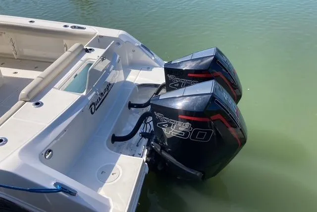 Slide: The Image of 2020 Boston Whaler 330 Outrage with twin Mercury Racing 450 engines in water. - 13