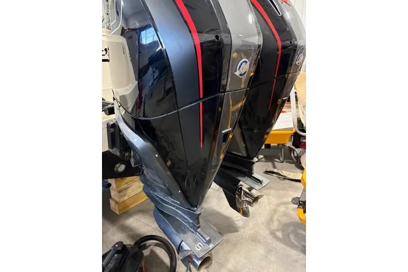 Slide: The Image of Twin outboard motors on a 2020 Boston Whaler 330 Outrage boat. - 18