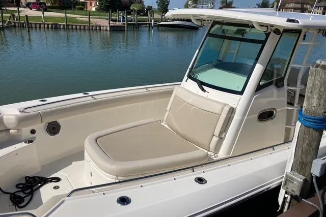 Slide: The Image of 2020 Boston Whaler 330 Outrage boat docked by calm waters. - 2