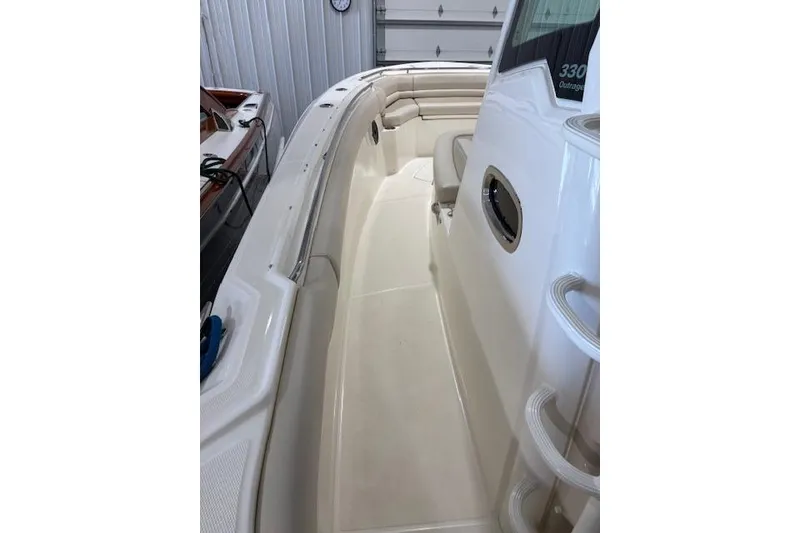 Slide: The Image of 2020 Boston Whaler 330 Outrage boat interior with seating and storage. - 26