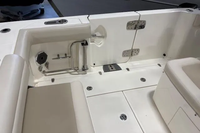 Slide: The Image of 2020 Boston Whaler 330 Outrage boat interior, featuring seating and storage compartments. - 30