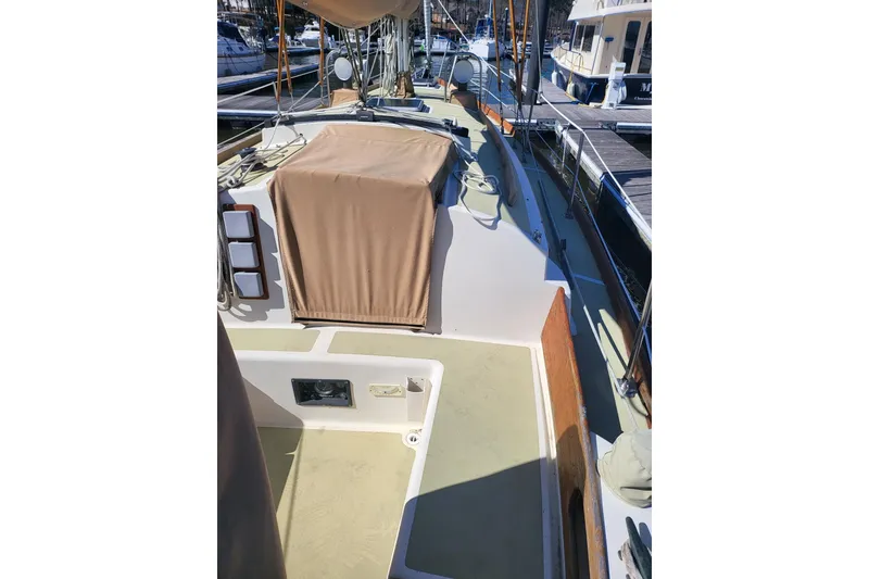 Slide: The Image of 1984 Sea Sprite 34 sailboat deck with tan covers and marina background. - 10