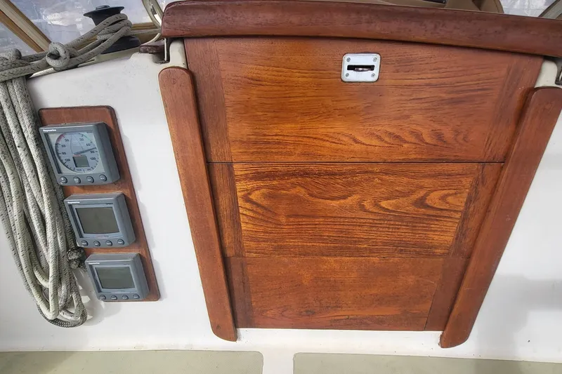 Slide: The Image of 1984 Sea Sprite 34 sailboat cockpit with wooden hatch and navigation instruments. - 12