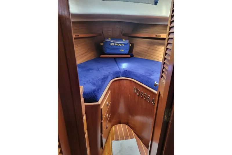 Slide: The Image of Cozy cabin interior of 1984 Sea Sprite 34 sailboat with blue bedding and life jackets. - 14