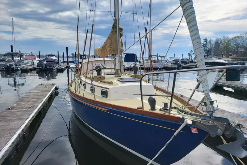 Slide: The Image of 1984 Sea Sprite 34 sailboat docked at marina, featuring classic design and blue hull. - 16