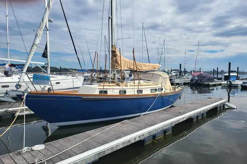 Slide: The Image of 1984 Sea Sprite 34 sailboat docked at a marina under cloudy skies. - 17