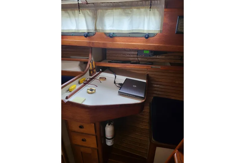 Slide: The Image of 1984 Sea Sprite 34 interior with navigation desk, laptop, and nautical tools. - 19