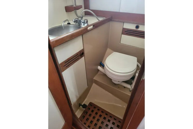 Slide: The Image of 1984 Sea Sprite 34 boat bathroom with sink and toilet. - 20