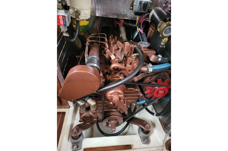 Slide: The Image of 1984 Sea Sprite 34 engine compartment with detailed mechanical components and wiring. - 21