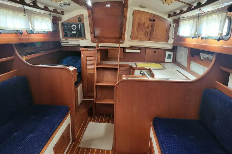 Slide: The Image of Interior of 1984 Sea Sprite 34 sailboat with wooden cabinetry and blue seating. - 27