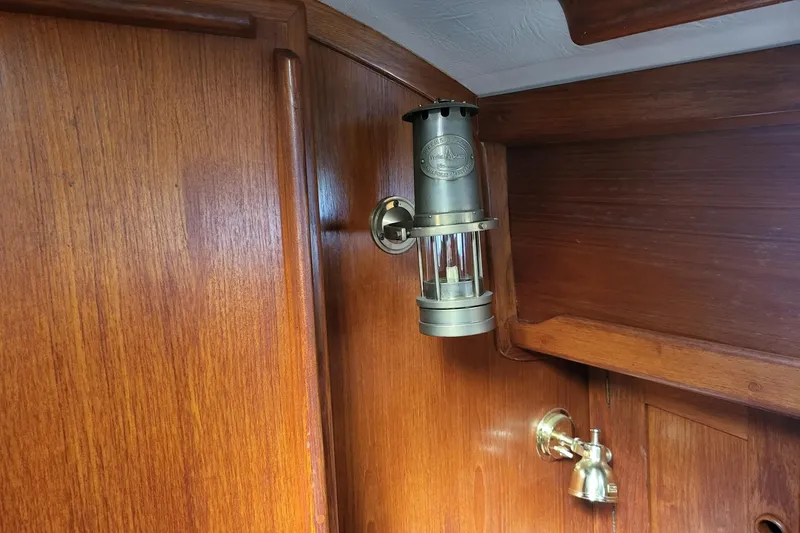 Slide: The Image of Vintage brass lamp and faucet on 1984 Sea Sprite 34 wooden interior. - 29